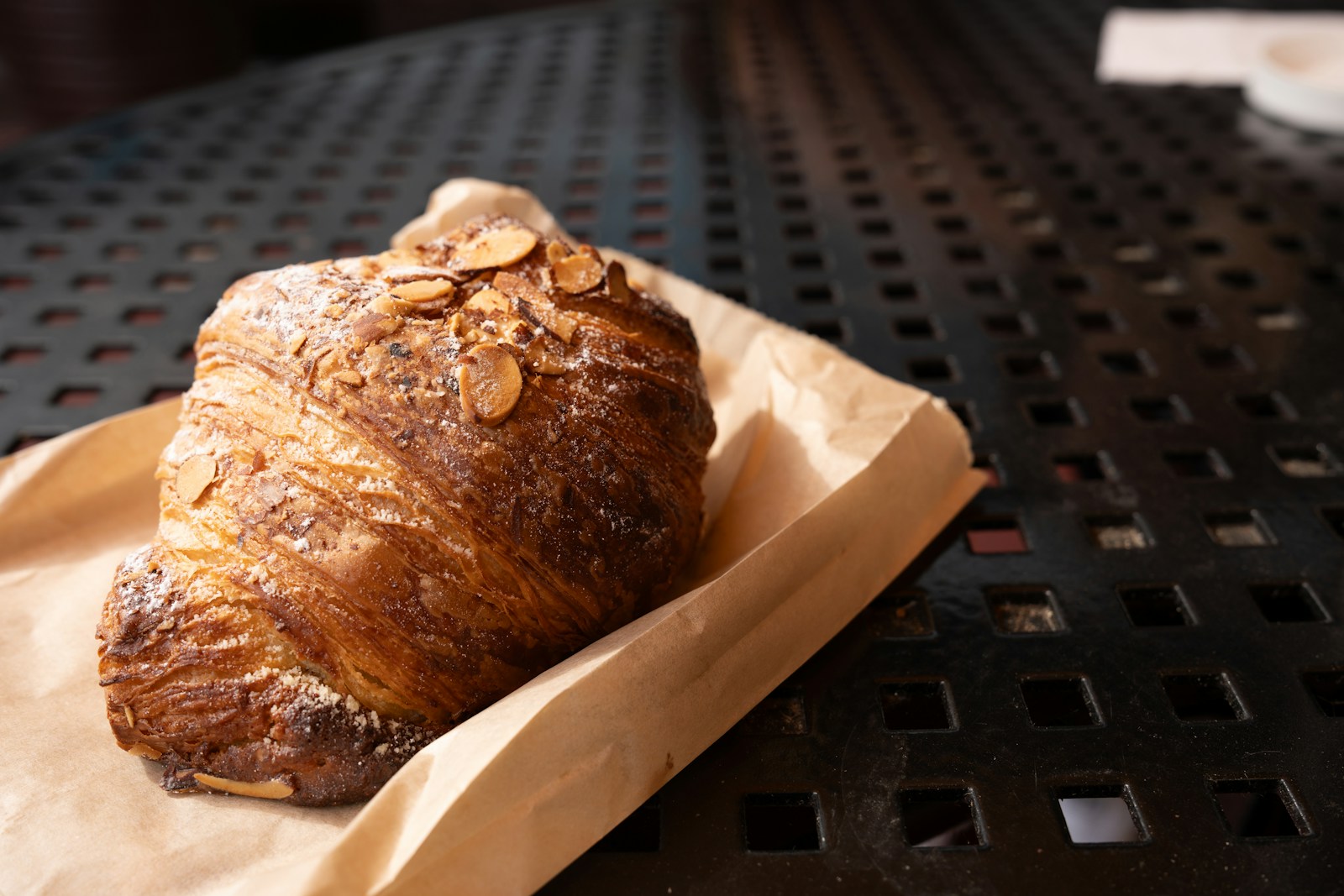 Delicious almond croissant on a table.